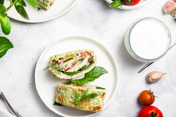 Appetizing zucchini roll with tomatoes and garlic on a light background