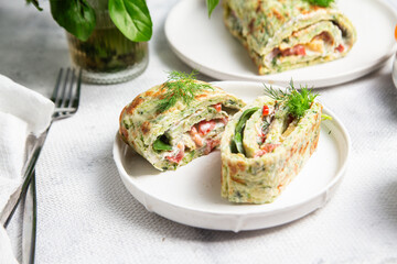 Appetizing zucchini roll with tomatoes and garlic on a light background