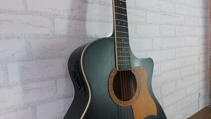 Obraz premium an elegant black acoustic guitar made of rosewood, with six steel strings that produce a melodious sound.