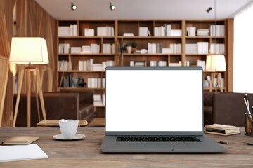 Modern workspace with open laptop on wooden desk, blank white screen