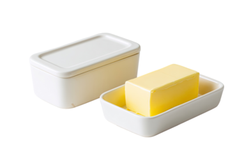 A white butter dish set with a lid and a tray, showcasing a block of yellow butter