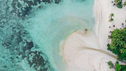 Luftaufnahme eines tropischen Strandes mit weißem Sand und türkisblauem Meer