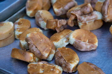 Traditional Indonesian street snack, pukis cake, freshly baked, placed on a metal tray, is ready to...