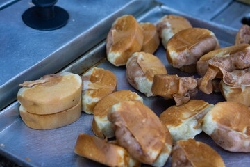 Traditional Indonesian street snack, pukis cake, freshly baked, placed on a metal tray, is ready to...