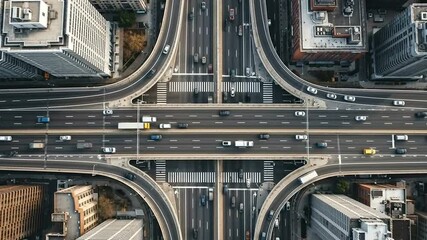 Ai generated aerial view of a busy city traffic intersection with cars and overpasses, representing urban transportation and infrastructure 4k video - Powered by Adobe