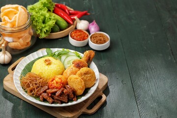 Nasi Kuning. Yellow rice is a typical Indonesian food. This food is made from rice cooked with turmeric, coconut milk and spices
