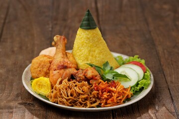 Nasi Kuning. Yellow rice is a typical Indonesian food. This food is made from rice cooked with...