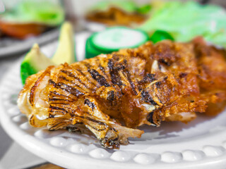 close up fried lionfish with vegetables dish (pterois volitans) cooking presentation