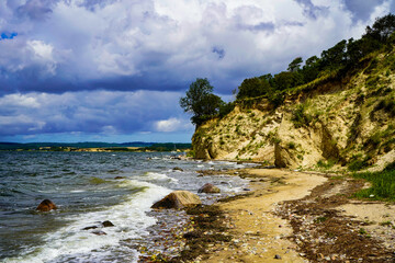 Scenic coastal landscape with steep cliffs and escarpments under a cloudy sky. Cliffs of the Baltic Sea, 18586 Mönchgut, Reddevitzer Höft, Rügen Island, Germany