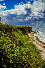Landscape and shoreline along the coast under a partly cloudy sky. Cliffs of the Baltic Sea, 18586 Mönchgut, Reddevitzer Höft, Rügen Island, Germany