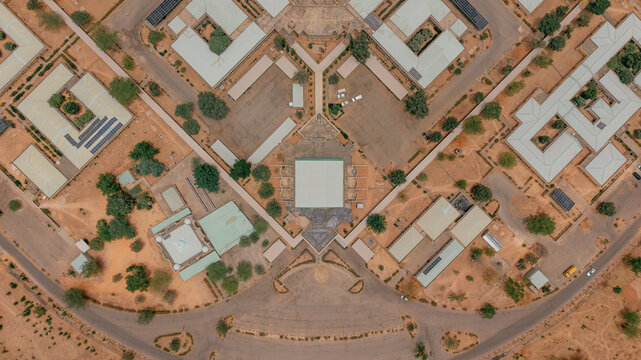 Aerial view of the neat geometric layout of the State Secretariat Complex in Katsina, with buildings and roads displaying earth tones and symmetrical patterns, Katsina, Katsina, Nigeria.