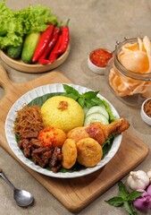 Nasi Kuning. Yellow rice is a typical Indonesian food. This food is made from rice cooked with turmeric, coconut milk and spices