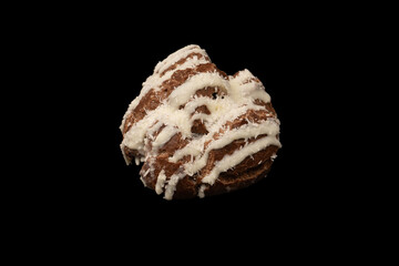 Profiteroles with coconut cream on a black background.