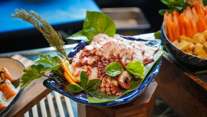 Fresh squid on a bright green plate