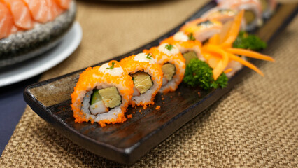 Delicious gourmet Japanese sushi rolls with fresh salmon and rice, a healthy appetizer on a plate