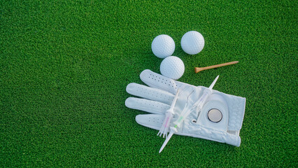 Close up of golf equipment on green grass.