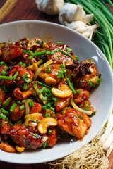 Authentic Chinese Kung Pao Chicken stir-fry with juicy chicken, peanuts, dried red chilies, and vegetables in a spicy savory sauce, traditional Sichuan recipe served in Asian restaurants worldwide
