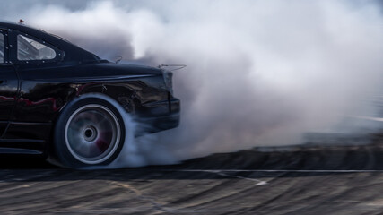 Car drifting, Blurred image diffusion race drift car with lots of smoke from burning tires on speed track, Car drifting on speed track, Professional driver drive drifting car. © Kalyakan
