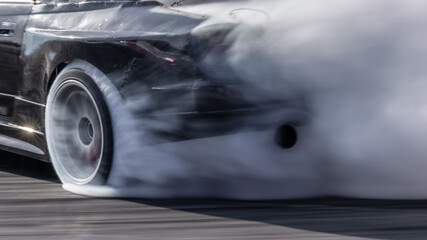 Car drifting, Blurred image diffusion race drift car with lots of smoke from burning tires on speed track, Car drifting on speed track, Professional driver drive drifting car. © Kalyakan