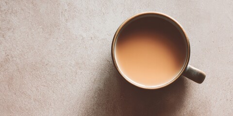 Warm Cup of Milk Tea on Textured Surface &ndash; Top View