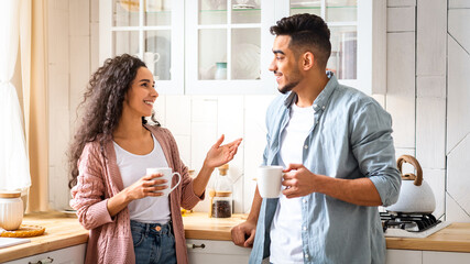 Home Leisure. Portrait Of Cheerful Middle Eastern Couple Spending Time In Kitchen Together, Happy...