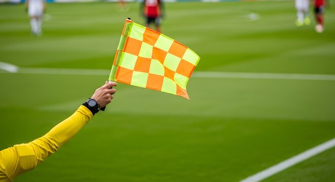 Soccer referee signaling a play during a match on a grassy field.