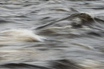 Closeup view of flowing river surface. Natur backgrounds or water texture.