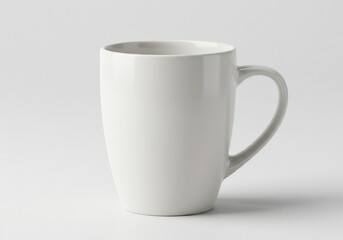 Fototapeta premium Simple white ceramic mug with curved handle on a neutral background