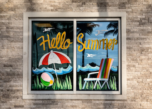 Hello Summer greeting message painted on the window at sunny day