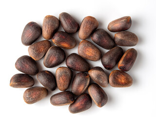 Obraz premium Unique and earthy pine seeds scattered on a white surface showcase their natural beauty and textures in detail
