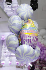 Birthday balloons on a table in a restaurant.