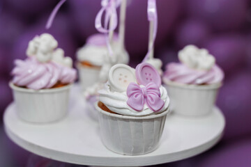 Purple cupcakes with decor for birthday party in restaurant.