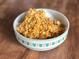 Bowl of Homemade Granola Clusters on a Wooden Table