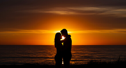 Fototapeta premium Silhouetted Couple Embracing at Sunset Over the Ocean.