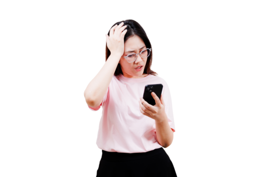 Asian young beautiful woman looks at her smartphone with a concerned expression, one hand on her head, wearing a pink shirt.