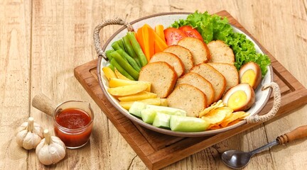 Selat Galantin is known for its combination of savory, sweet, and fresh flavors from its distinctive sauce, served with chicken or beef galantin.