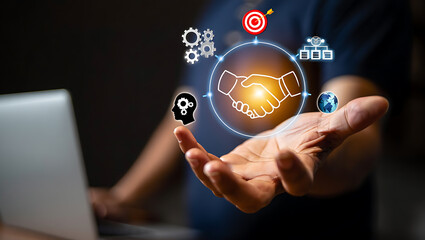Hand holding business strategy icons with handshake and globe partnership global