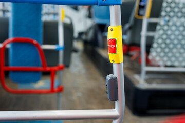 Public transportation stop request button on bus interior.