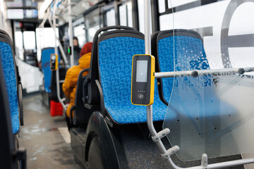 Paying contactless with plastic card for the public transport in bus. Payment terminal in the bus.