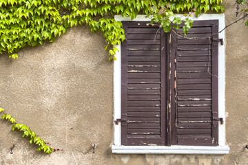 Still life shows old wooden shutters on European building