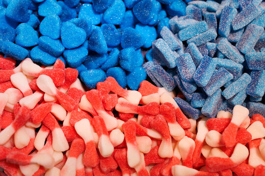 Lot of acidic sweets in the window in the store. Sour gummy candy - Powered by Adobe