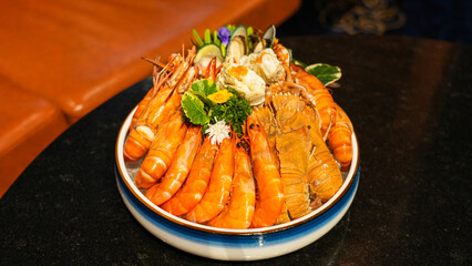 Grilled shrimp with fresh vegetables and red sauce on a plate