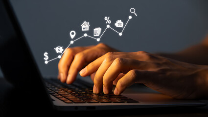 Hands typing on laptop with financial growth chart image
