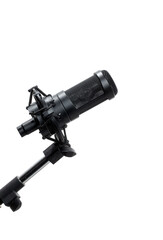 Professional studio microphone against a black background. Close-up of a black studio microphone on a stand, isolated against a pure black background.