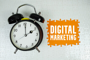 Digital Marketing text with alarm clock on orange background