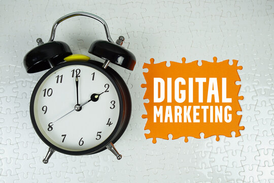 Digital Marketing text with alarm clock on orange background