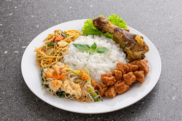 Indonesian traditional food Nasi campur or nasi berkat. rice with various side dishes