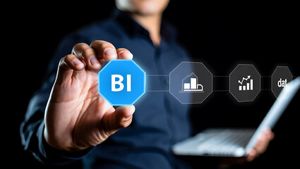 Naklejka premium Person holding blue octagon with B I and data graphics business intelligence data analysis