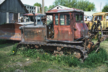 Fototapeta premium Rusty Soviet Bulldozer in an Abandoned Machinery Yard