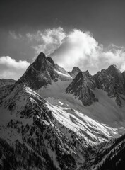 Obraz premium Black and white mountain range, snow-capped peaks, dramatic clouds